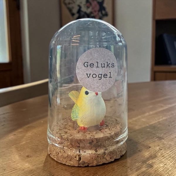 Geluksvogel in stolp geel